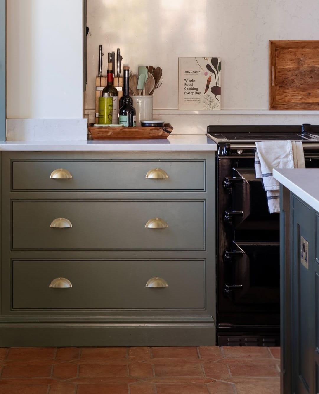 Sage green and terracotta kitchen