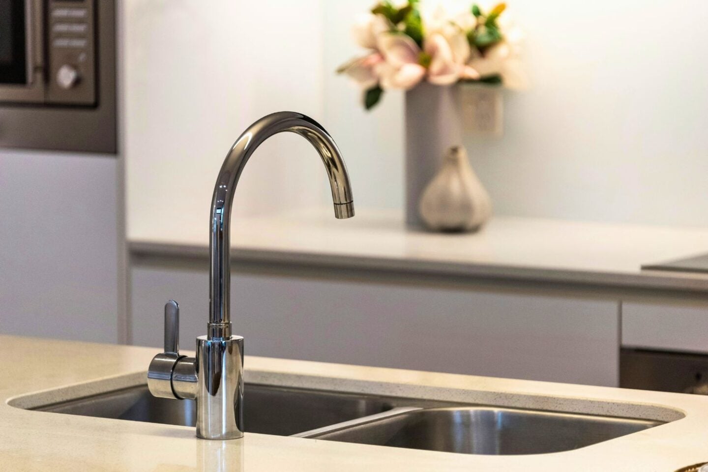 Stylish kitchen sink and brass mixer tap after a refit